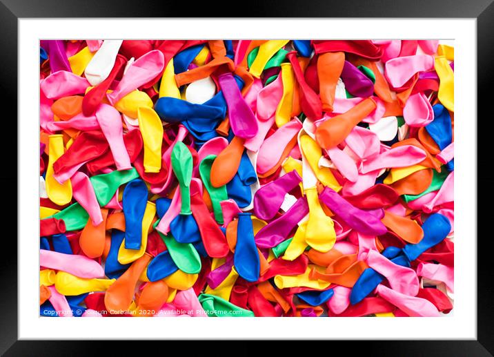 Close-up of many colorful children's balloons, background for motifs of colorful children's parties. Framed Mounted Print by Joaquin Corbalan