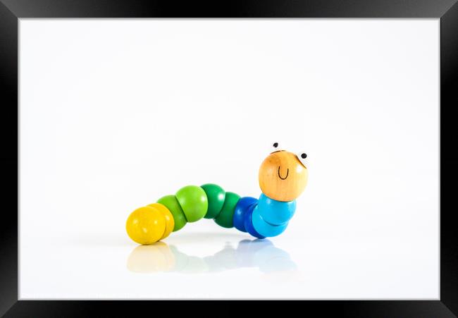 Toy caterpillar with smile, to illustrate concepts of infant intestinal health. Framed Print by Joaquin Corbalan