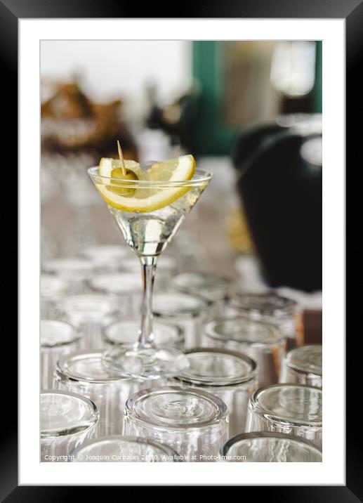 Cup of gin and tonic, with a slice of lemon and olive. Framed Mounted Print by Joaquin Corbalan