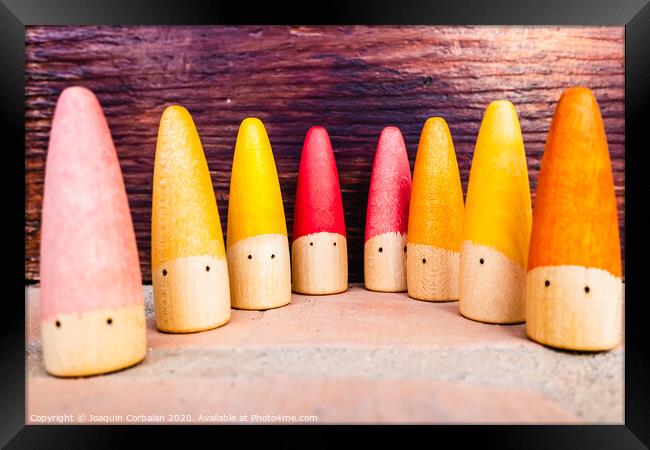 Set of colored wooden conical fish toys for unstructured children's games. Framed Print by Joaquin Corbalan