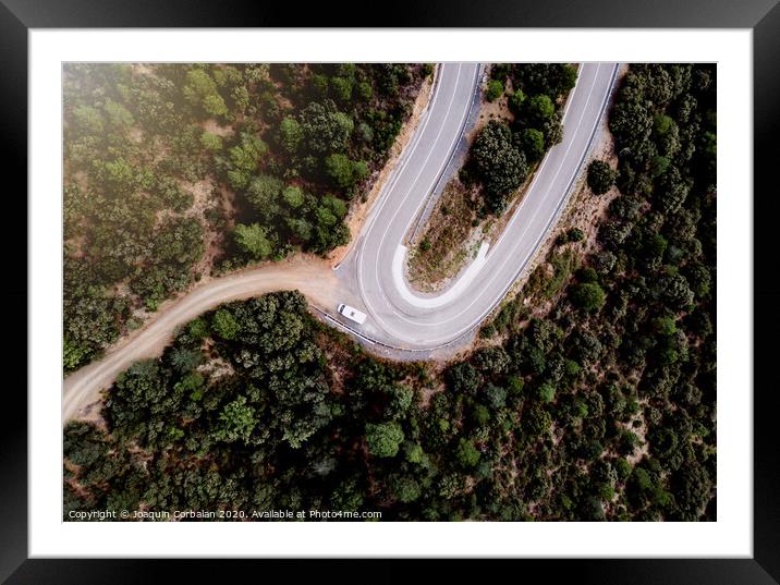 Motorhome parked on the curve of a mountain road, seen from above, of some tourists on the road. Framed Mounted Print by Joaquin Corbalan