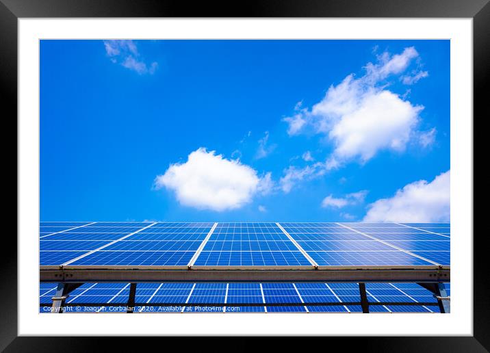 The sun converts its light into electrical energy through silicon solar panels, copy space. Framed Mounted Print by Joaquin Corbalan