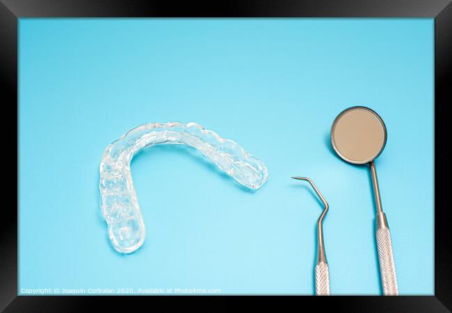 Dentist material to treat bruxism with dental splints, isolating on medical background Framed Print by Joaquin Corbalan