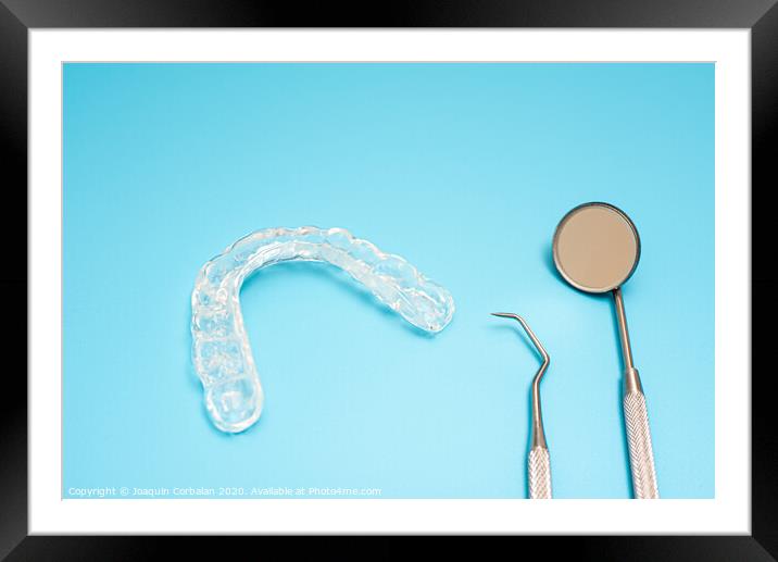 Dentist material to treat bruxism with dental splints, isolating on medical background Framed Mounted Print by Joaquin Corbalan