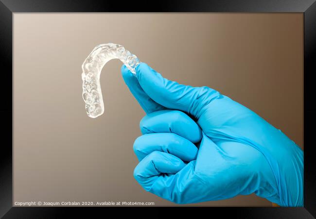 Dentist material to treat bruxism with dental splints, isolating on medical background Framed Print by Joaquin Corbalan