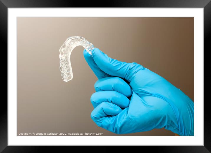 Dentist material to treat bruxism with dental splints, isolating on medical background Framed Mounted Print by Joaquin Corbalan