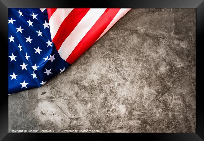 Striking colored American flag isolated in a corner on a stone gray background. Framed Print by Joaquin Corbalan