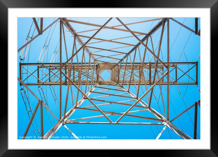 Electricity is transported by thick cables attached to metal towers. Framed Mounted Print by Joaquin Corbalan