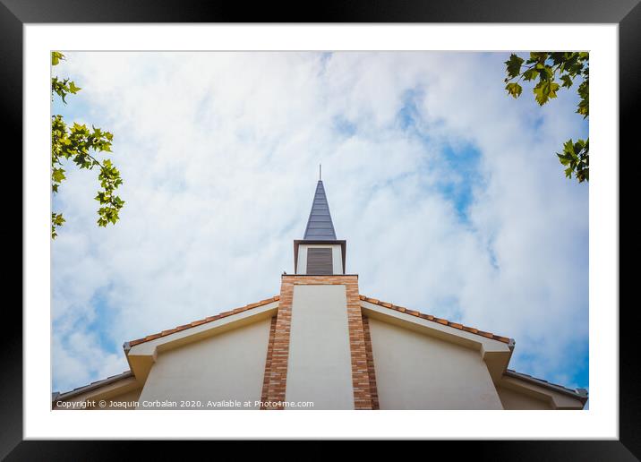 Facade of an evangelical church with smooth white walls and a cloudy sky background. Framed Mounted Print by Joaquin Corbalan