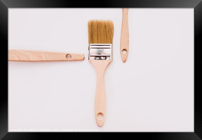 Simple background with new wooden paintbrushes isolated on white studio background. Framed Print by Joaquin Corbalan
