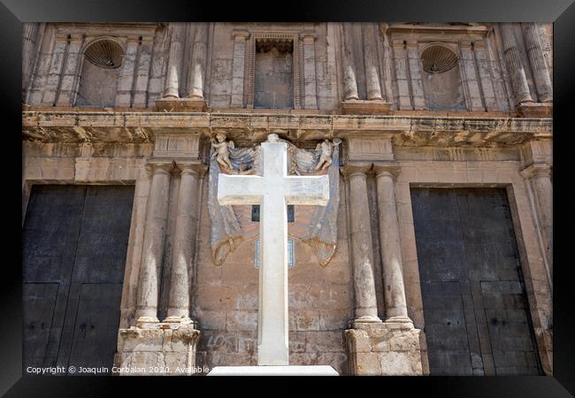 Cross carved in white stone, erected in front of a Christian religious church. Framed Print by Joaquin Corbalan