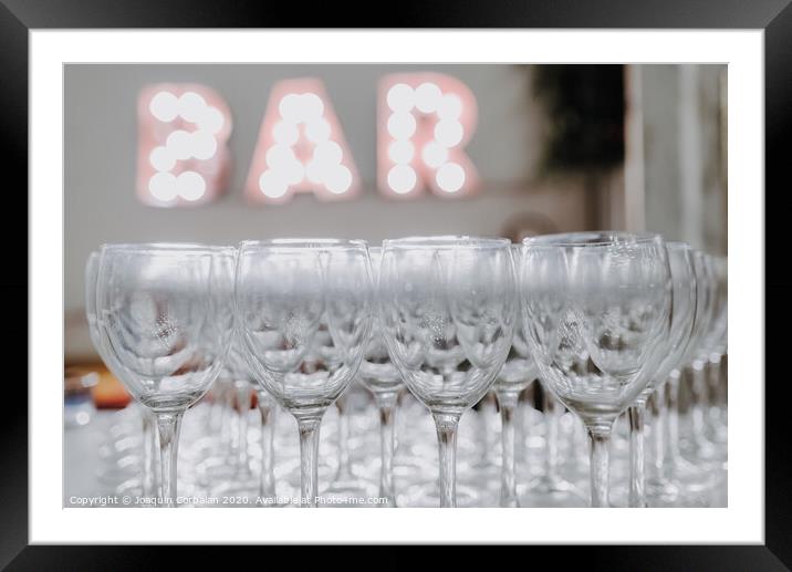 Empty glasses on a bar counter for drinking alcohol. Framed Mounted Print by Joaquin Corbalan