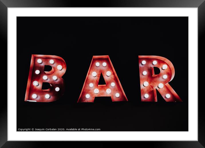 Bar written with luminous bulbs on a dark black background. Framed Mounted Print by Joaquin Corbalan