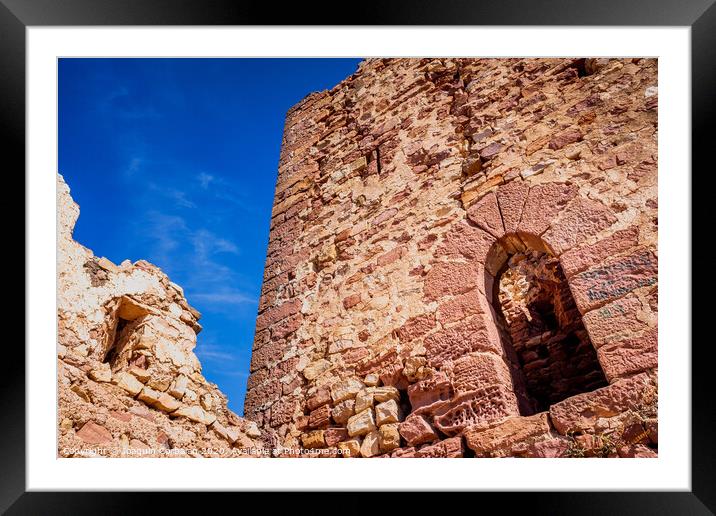 Walls of an old abandoned European castle with blue sky background. Framed Mounted Print by Joaquin Corbalan
