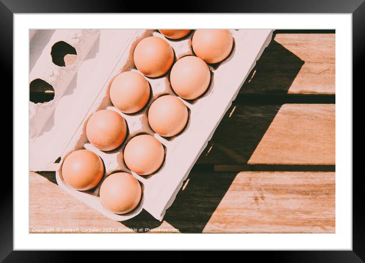 Recycled cardboard box with fresh eggs, viewed from above. Framed Mounted Print by Joaquin Corbalan