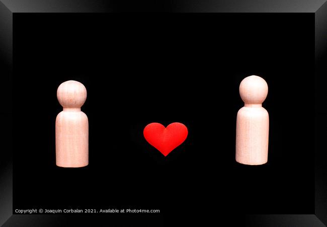 Wooden figures representing a homosexual couple of two gay men in love, with a beautiful red heart, isolated on a black background. Framed Print by Joaquin Corbalan