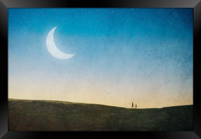 A magical concept. Of a couple walking on a hill w Framed Print by David Wall