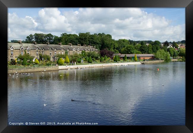 Cottages and Gardens Along a River Bank. Framed Print by Steven Gill