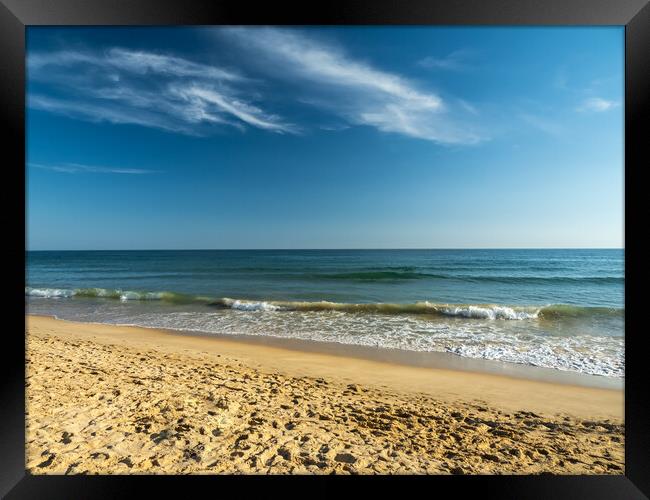 Waves lapping the shoreline of Falesia Beach  Framed Print by Tony Twyman