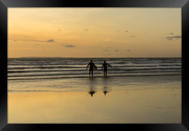 sunset surfers at Westward Ho in North Devon Framed Print by Tony Twyman