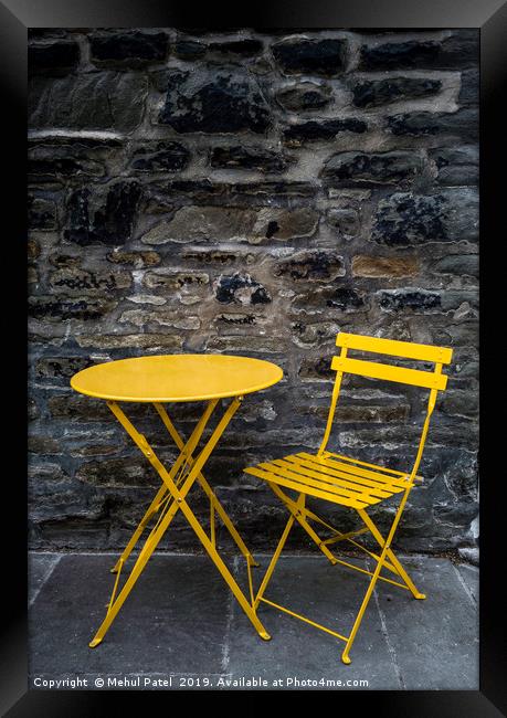 Yellow chair and table by stone wall  Framed Print by Mehul Patel