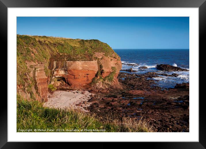 Steep rock face and secluded rock beach at Seaton  Framed Mounted Print by Mehul Patel