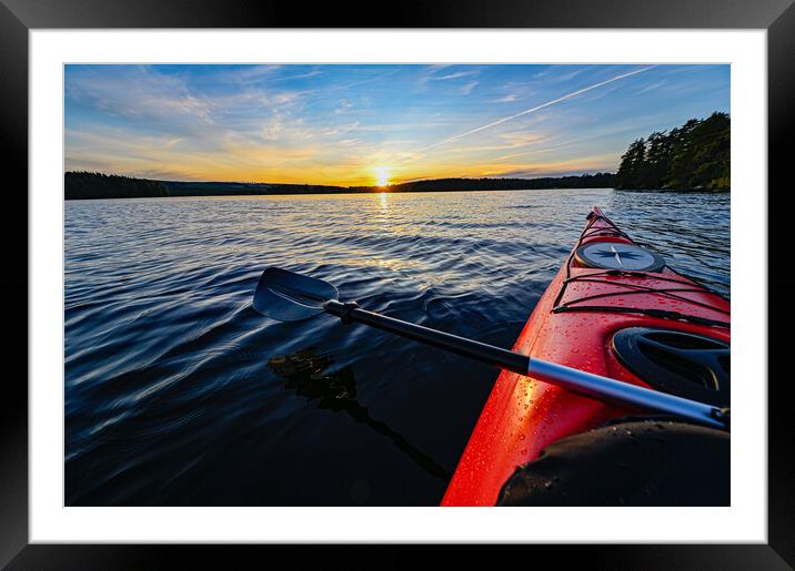 red plastic kayak on calm water in the sunset Framed Mounted Print by Jonas Rönnbro