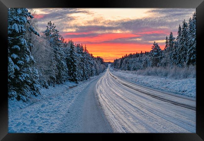 winter road in Varmland Sweden and orange sunrise Framed Print by Jonas Rönnbro