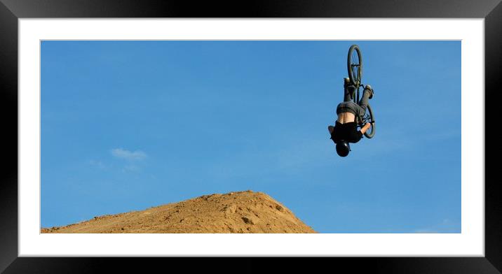 A person on trial bicycle flying over the camera Framed Mounted Print by M. J. Photography