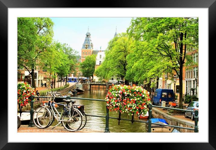 A bicycle parked on the side of a river in Amsterd Framed Mounted Print by M. J. Photography