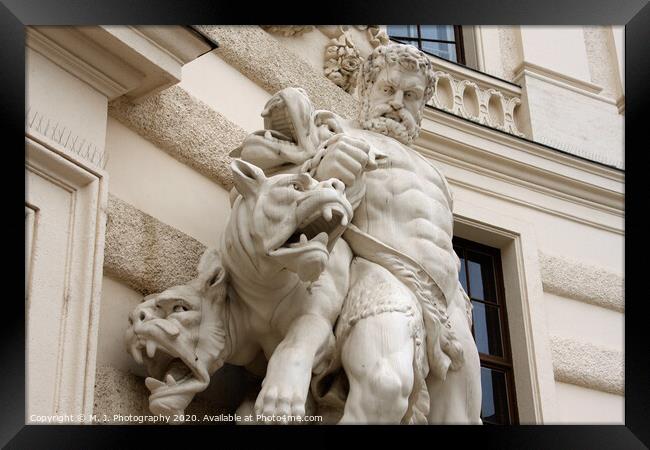 Antique scene of fight between man and mythical creatures on The Hofburg palace in Vienna Framed Print by M. J. Photography