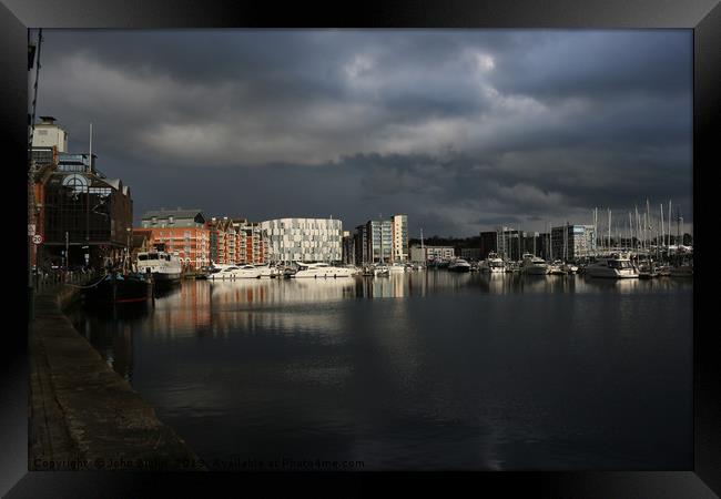 Ipswich waterfront marina with storm clouds Framed Print by John Biglin