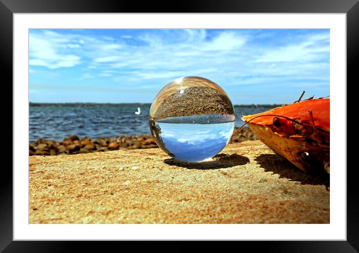 Glass orb on seashore Framed Mounted Print by Martin Smith