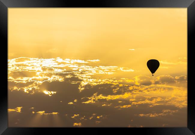 hot air balloon in the sky with orange sunrise clouds Framed Print by David Galindo