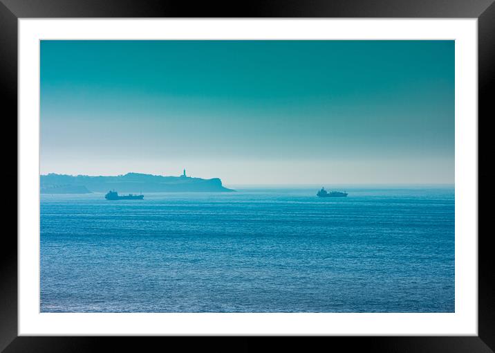 cargo ships with lighthouse in the background Framed Mounted Print by David Galindo