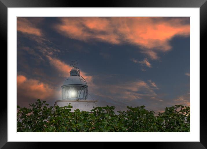maritime lighthouse lit with sunset sky Framed Mounted Print by David Galindo