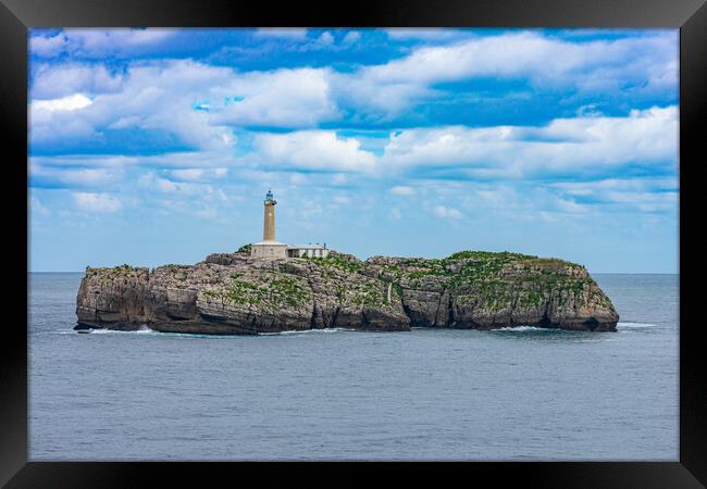 close view of a rock islet in the sea with a lighthouse Framed Print by David Galindo