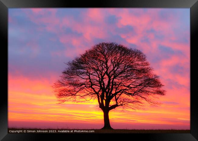 A sunset over a body of water Framed Print by Simon Johnson