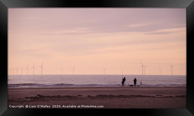 Pulling in the catch as the Sun Sets in Hoylake Framed Print by Liam Neon