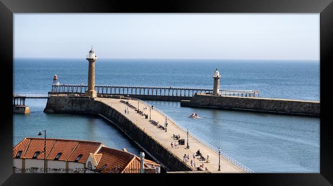 The Piers in Whitby harbour Framed Print by Chris Yaxley