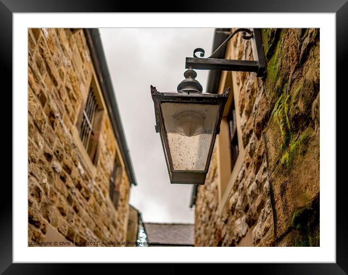 Victorian style light on an old and historic building in a narrow alley way Framed Mounted Print by Chris Yaxley