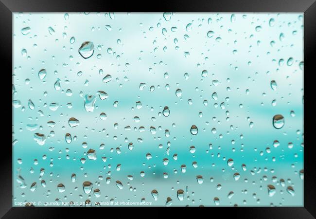 Drops on a window glass with blurry blue background Framed Print by Laurent Renault