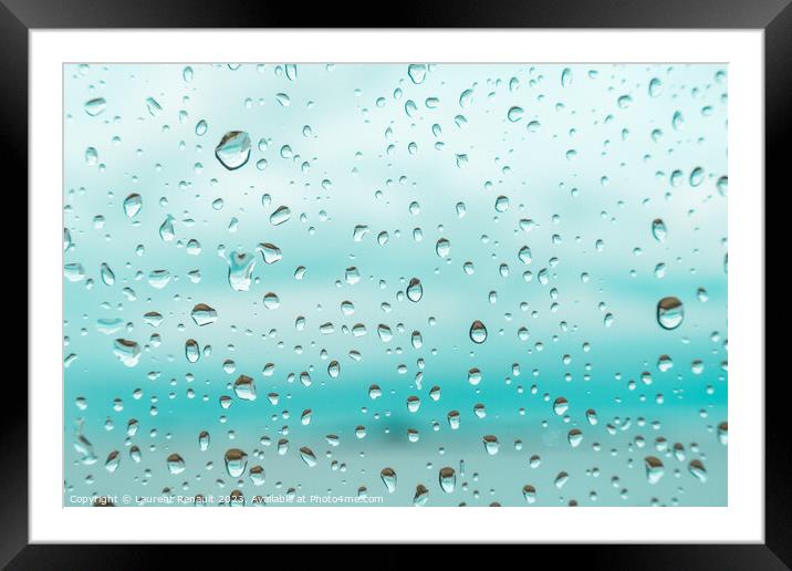 Drops on a window glass with blurry blue background Framed Mounted Print by Laurent Renault