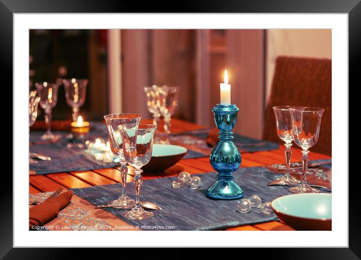 Dining table setting with glasses, decorations and candles Framed Mounted Print by Laurent Renault