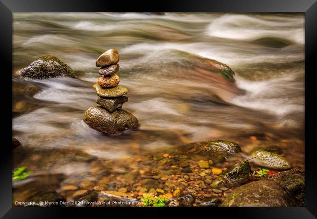 Stones in a zen position in a river in Costa Rica Framed Print by Marco Diaz