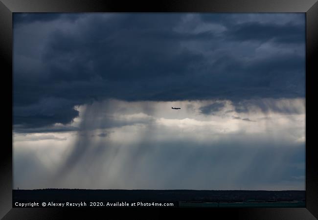 Air jet and the storm cloud. Moscow, Russia. Framed Print by Alexey Rezvykh