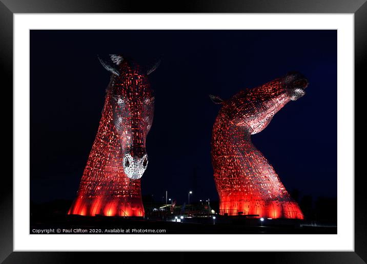 The Kelpies in red. Framed Mounted Print by Paul Clifton