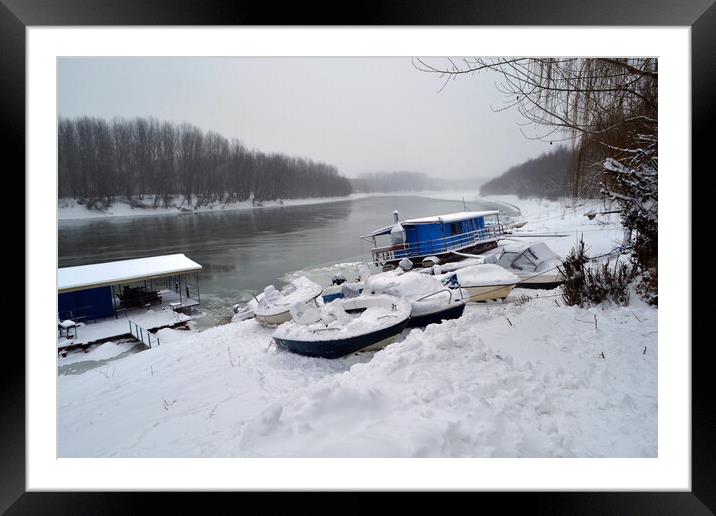 Boats under the snow on the river Borcea  Framed Mounted Print by liviu iordache