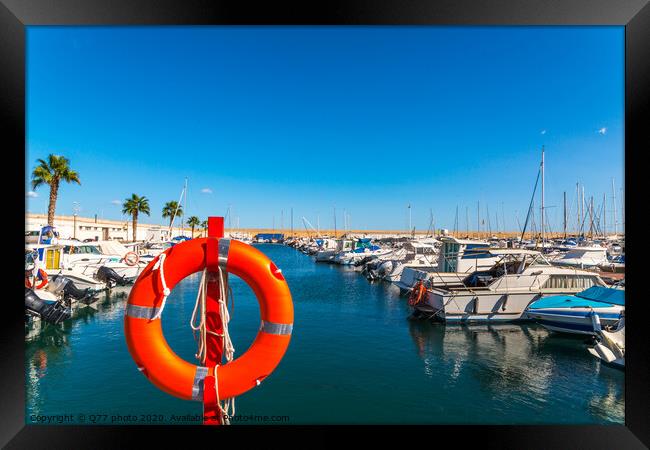 Beautiful luxury yachts and motor boats anchored in the harbor, hot summer day and blue water in the marina, blue sky Framed Print by Q77 photo