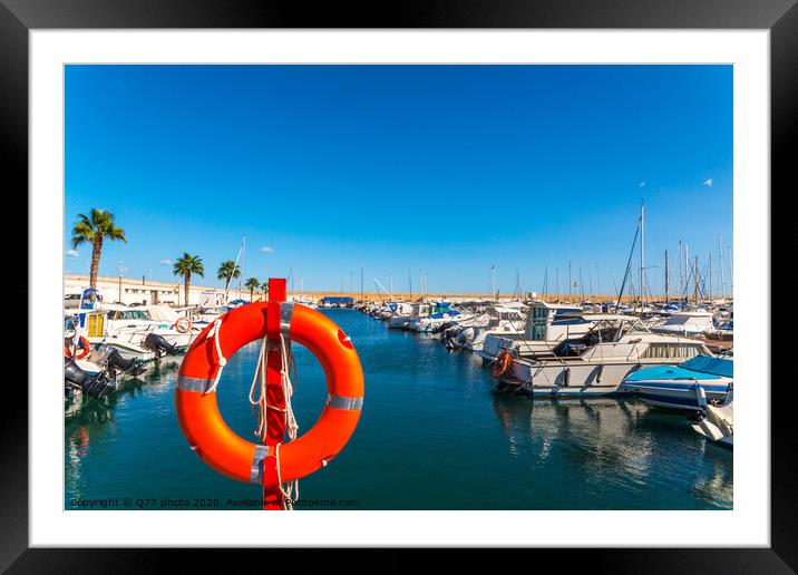 Beautiful luxury yachts and motor boats anchored in the harbor, hot summer day and blue water in the marina, blue sky Framed Mounted Print by Q77 photo
